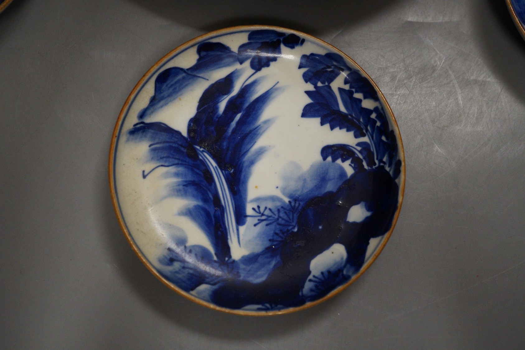 Three Japanese Arita dishes and a Chinese dragon plate, largest 23cm diameter